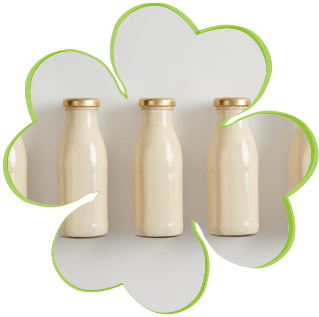 row of glass bottles of milk with dairy flavors