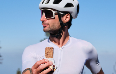 Cyclist eating an on-the-go bar for morning energy