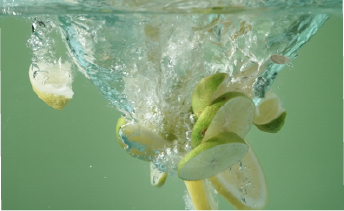 Lemon slices splashing into water, symbolizing a clean, neutral flavor base.