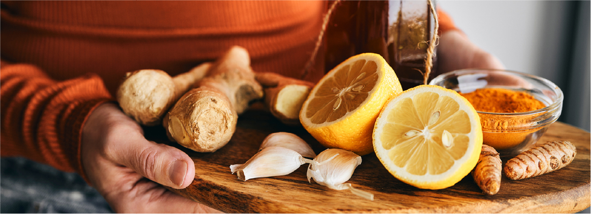 Fresh citrus, garlic, and herbs on a cutting board representing balanced, natural flavor creation.