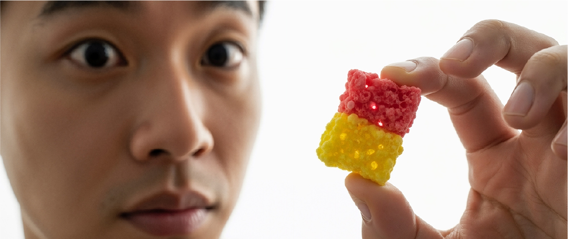 A person examining two stacked gummy candy cubes, highlighting how texture influences food perception.