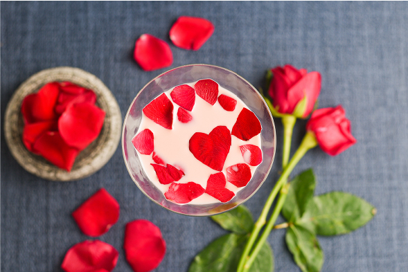 Rose petals and a glass dropper representing how fat, sugar, and acidity alter delicate floral flavor compounds.