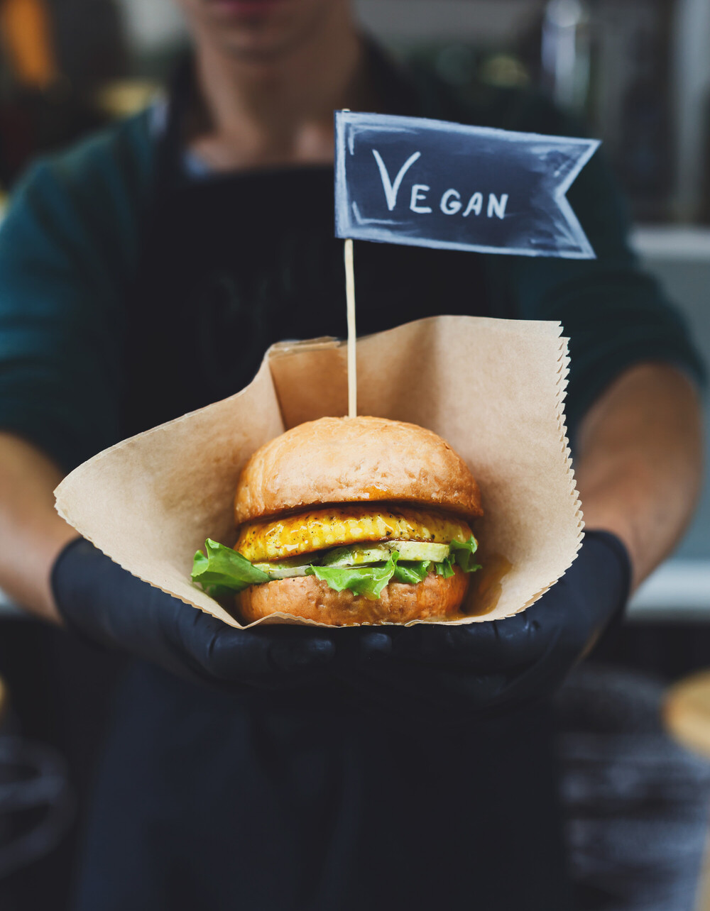 Vegan burger served with a “VEGAN” flag, highlighting plant-based choices and shifting consumer taste behavior