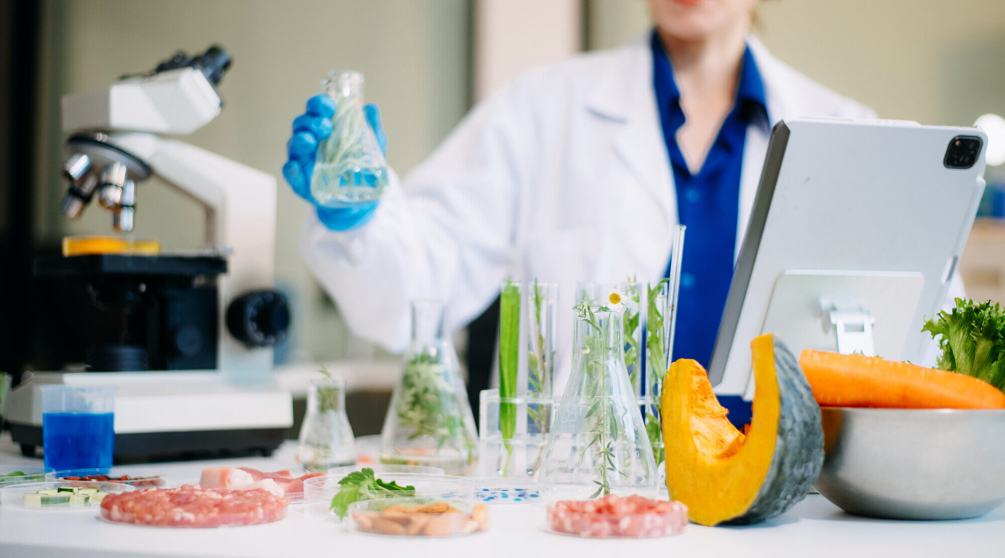 Food scientist in a lab with produce and samples, showing flavor innovation guided by the science of taste