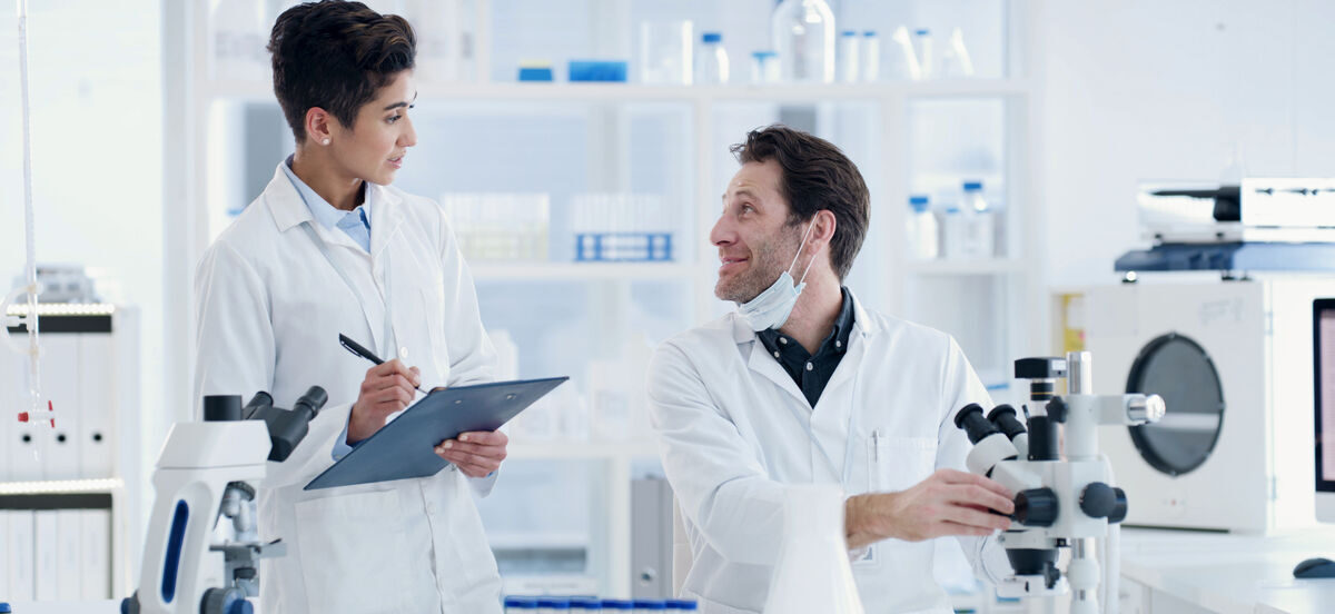 R&D scientists reviewing samples and data to build matrix-specific strawberry flavoring systems.