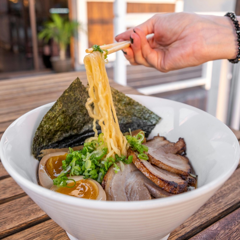 Tonkotsu garlic ramen bowl with pork, building broth depth beyond generic “umami ramen