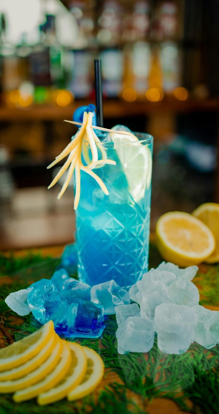 Bright blue cocktail with citrus garnish, a playful color that can read artificial outside candy-style contexts.
