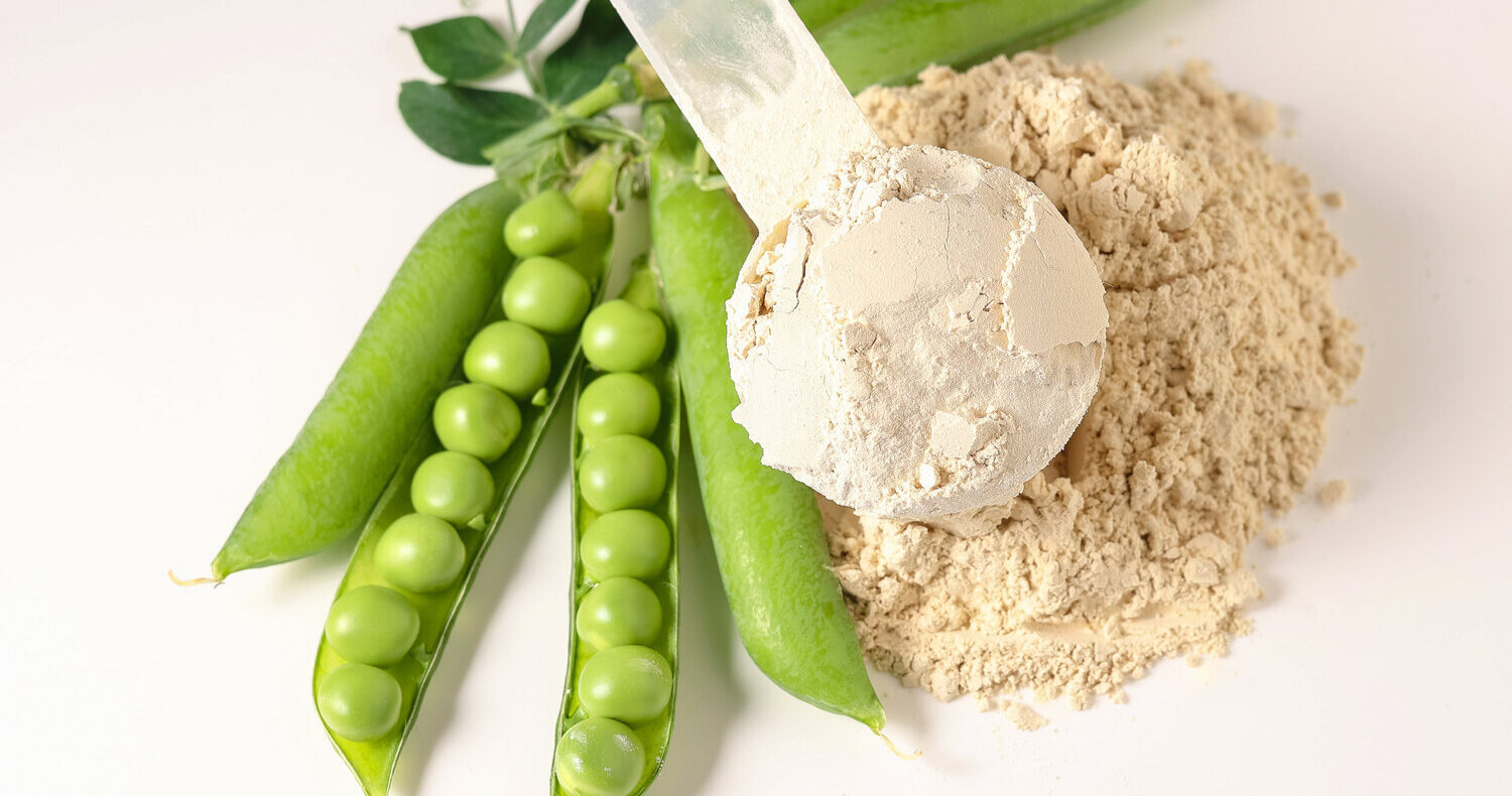 Pea protein powder with green peas, showing how processing can change protein flavor and create beany notes.