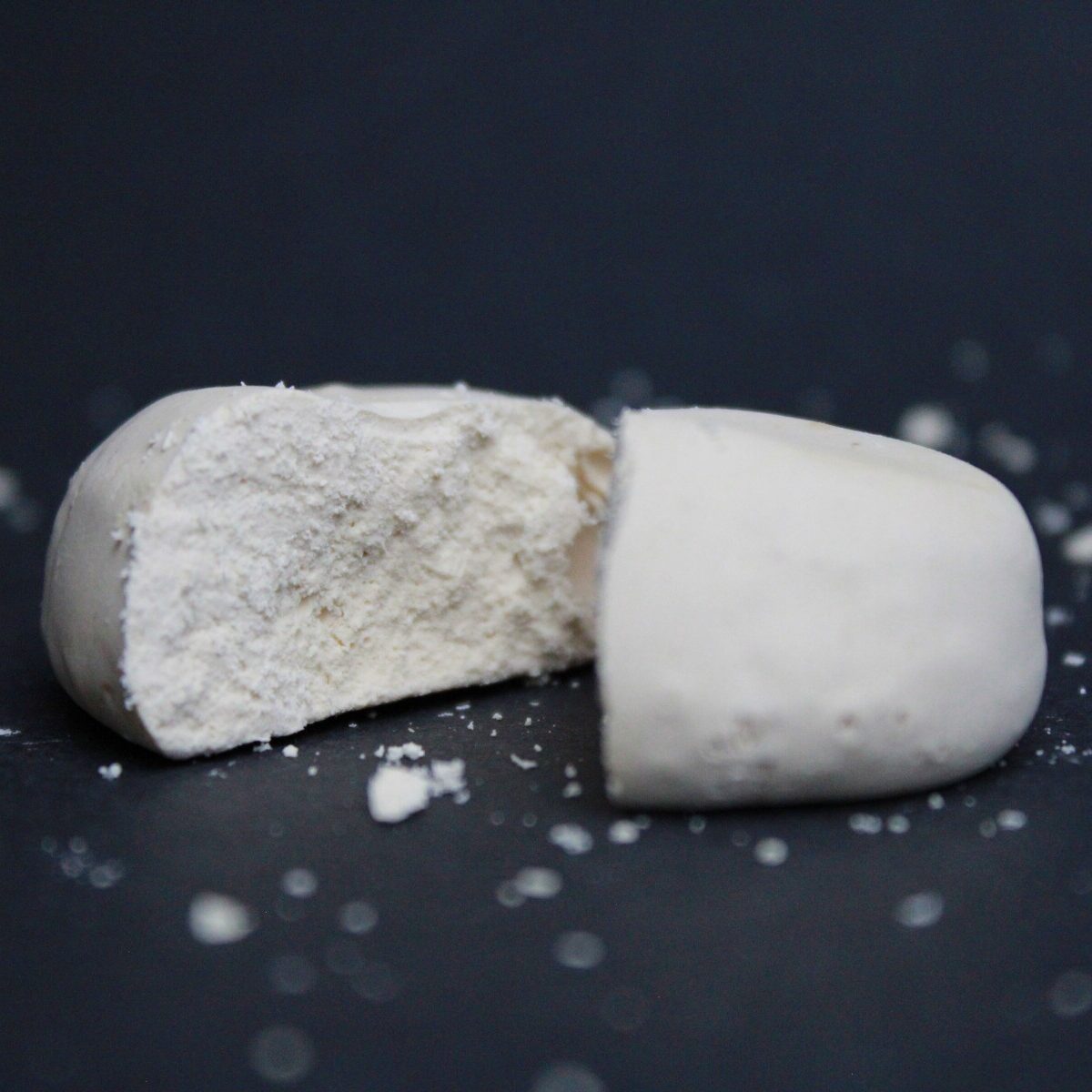 Chalky protein sample on a dark surface, highlighting mouthdrying, astringency, and texture breakdown.