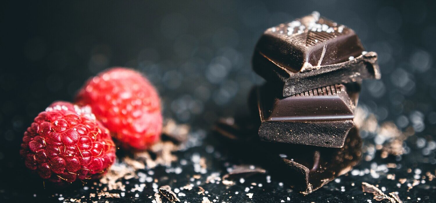 Dark chocolate and raspberries, showing bitter flavor balanced by roast, fruit, fat, and sweetness.