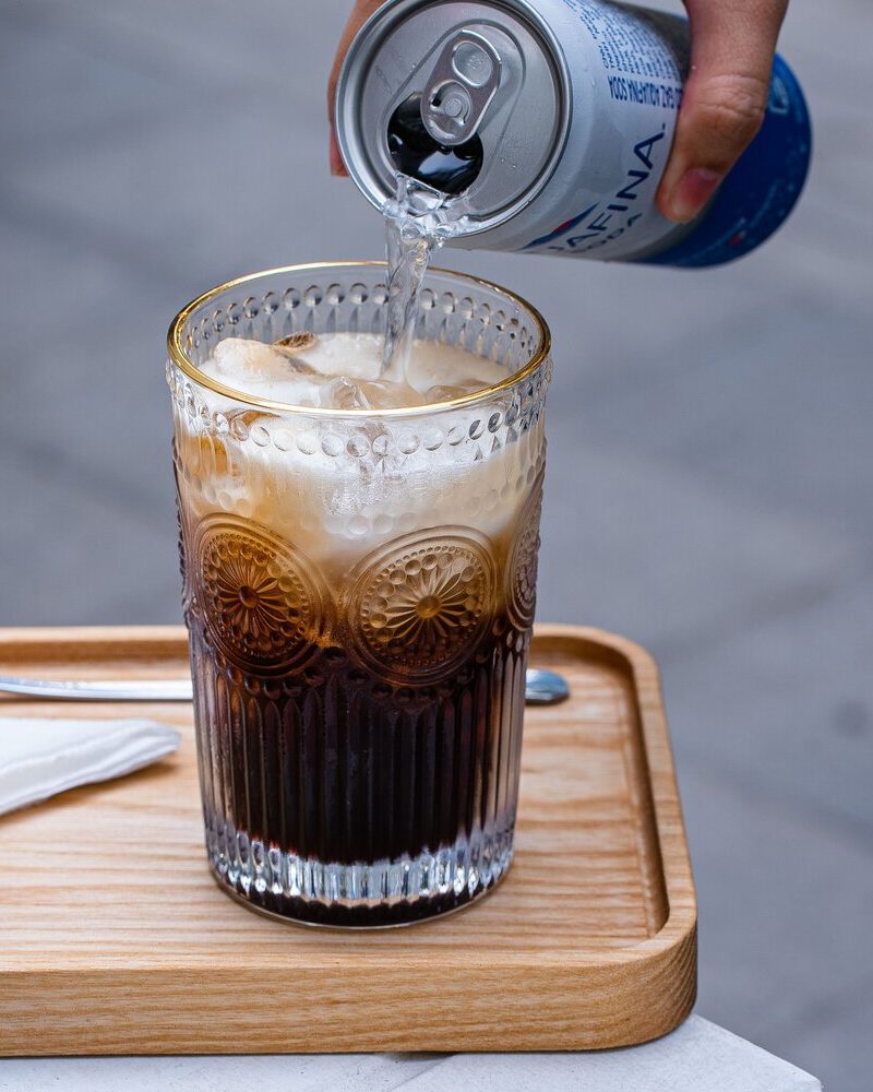 Bitter flavor in a zero-proof style drink, showing adult cues from coffee, citrus peel, and herbal complexity.
